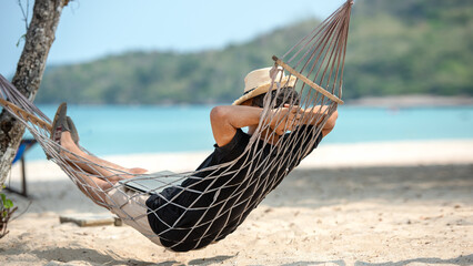 Lifestyle freelance man relax and sleeping on the hammock after using laptop working and relax on...
