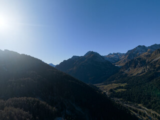 Fototapeta premium Aerial view of alpine landscape at Swiss Maloja mountain pass on a sunny autumn day. Photo taken November 15th, 2024, Maloja Bregaglia, Switzerland.