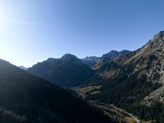 Aerial view of alpine landscape at Swiss Maloja mountain pass on a sunny autumn day. Photo taken November 15th, 2024, Maloja Bregaglia, Switzerland.