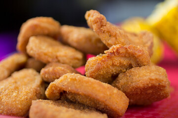 Close-up of golden crispy chicken bites, showing crunchy exterior and tender interior, ideal for fast food menus and gourmet presentations.