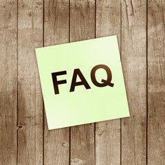 FAQ Text Frequently Asked Questions. FAQ written on a white business card against a background