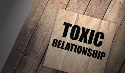 Toxic relationship word Brown torn paper with yellow background. Addictions, quit smoking and...