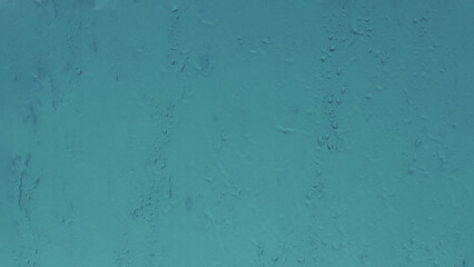 Abstract water drops on glass surface.