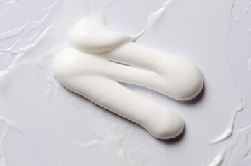 A sample of a white moisturizing cosmetic cream for the body or face
