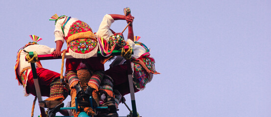 Authentic mexican dancers at Papantla, Veracruz performing the flying ritual dance, close-up.