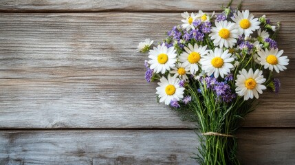 Daisies and wildflowers bouquet on rustic wooden background
