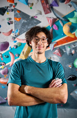 Climber portrait against steep wall in climbing gym