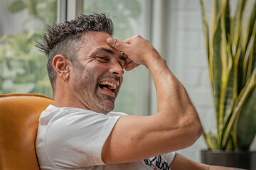 man at home happy laughing out loud