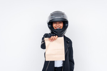 A friendly young Asian woman delivery rider delivering a takeout food order in a paper bag. Isolated on a white background.