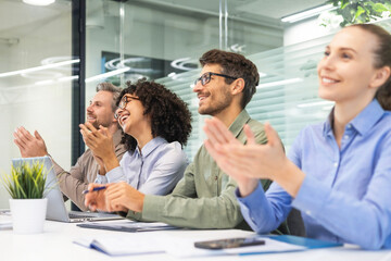 Image of colleagues clapping hands at seminar, listening speaker. Business education