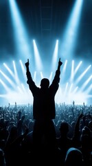 Silhouetted concert crowd raises hands under intense blue stage lights, creating an energetic and lively atmosphere.