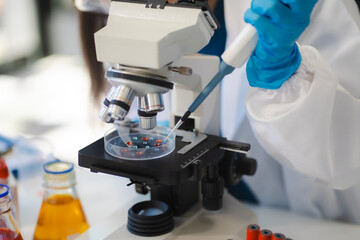 Female biotechnologist testing new chemical substances in a laboratory.