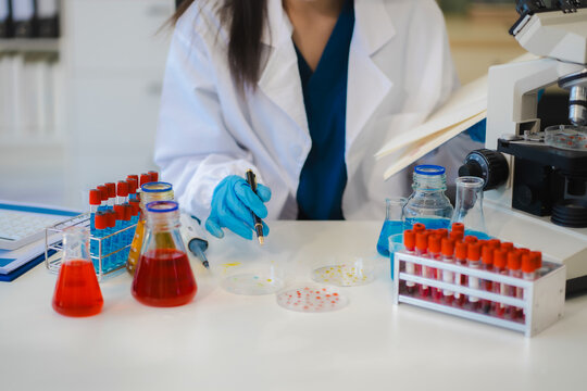 Female biotechnologist testing new chemical substances in a laboratory.