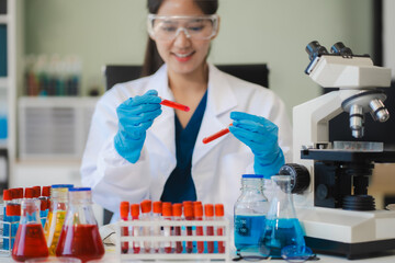 Female biotechnologist testing new chemical substances in a laboratory.