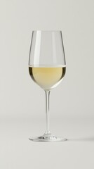 A glass of white wine or champagne is elegantly filled, capturing a sense of celebration against a soft, neutral background.