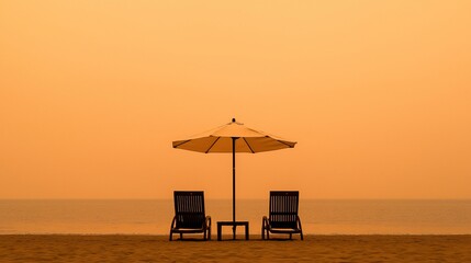 Fototapeta premium Beach chairs and umbrella at sunset.