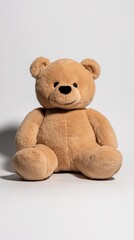 Obraz premium A plush teddy bear is sitting against a white background, creating a cozy and inviting scene.