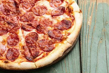 Pizza pepperoni fast food . Top view on rustic background