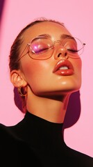 A stylish portrait of a woman with sunglasses and closed eyes, set against a vibrant pink background. The lighting accentuates her glossy lips and smooth skin.