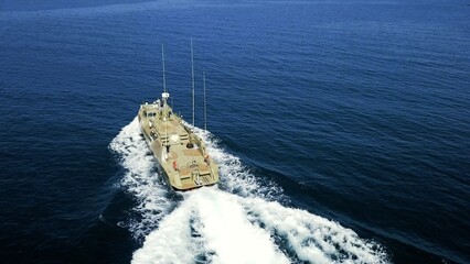 drone view - coast guard speed boat at full speed