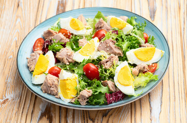 Canned Tuna salad with eggs and tomatoes photography . Top view