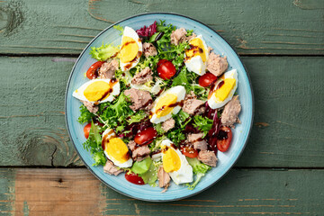 Canned Tuna salad with eggs and tomatoes photography . Top view