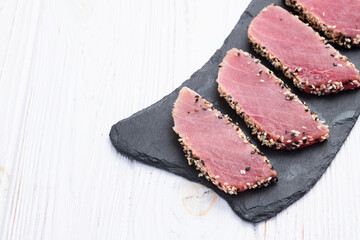 Sliced tuna steak with sesame photography . Top view