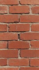 Panoramic view of a vintage red brick wall with visible mortar lines, showcasing the texture and rustic charm of old masonry.