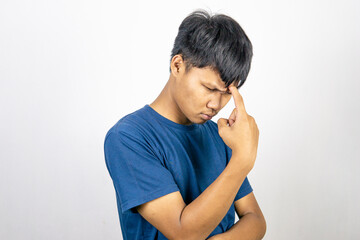 Young Asian man wear blue t-shirt with thinking and looking idea gesture