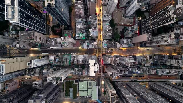 Hong Kong: Aerial top downdrone footage of the streets at night of the very crowded Sai Wan and Sai Ying Pun districts in Hong Kong island. 