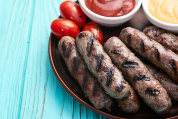 Grilled beef sausages with rosemary sauce and tomatoes photography . Top view