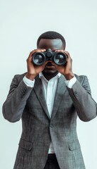 Businessman using binoculars to discover solutions and opportunities in the corporate world