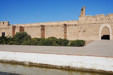 Scenic El Badi palace reflected in water in Marrakech city in Morocco
