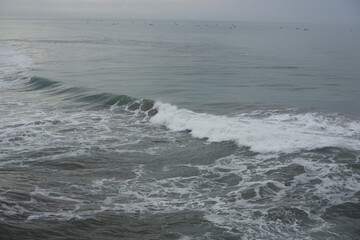 rolling waves with white foam creating intricate patterns on the sea surface