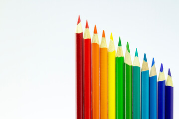 Colorful rainbow arrangement of sharpened pencils against a white background. Pride Celebration.