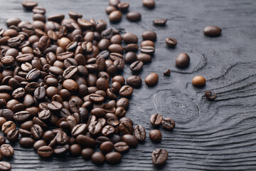 Coffee beans on the dark wooden background