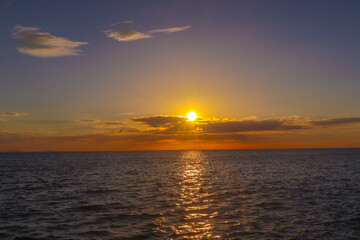 Landscape A stunning sunset paints the sky with vibrant hues of orange and purple as the sun dips below the horizon, reflecting its warmth on the calm ocean. (3)