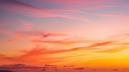 Fototapeta premium The beauty of luxurious soft gradient clouds in orange and gold, bathed in sunlight against the blue sky, makes for the perfect evening twilight backdrop.