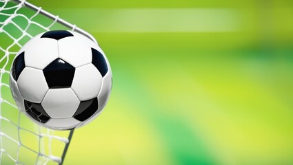 Soccer ball resting in the goal, illuminated by sunlight.