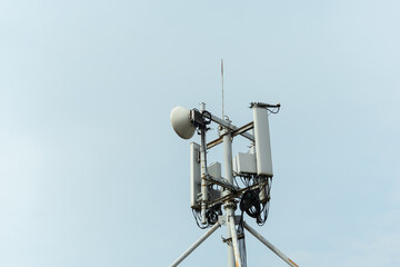 Telecommunication tower with antennas reaching for the clear sky in an urban area during daylight...