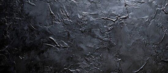 Dark gray and black textured background with intricate details and rough surface ideal for overlaying text or design elements