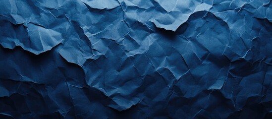 Fototapeta premium Deep Blue Crumpled Paper Texture Background with Subtle Shadows and Ample Space for Text or Design Elements