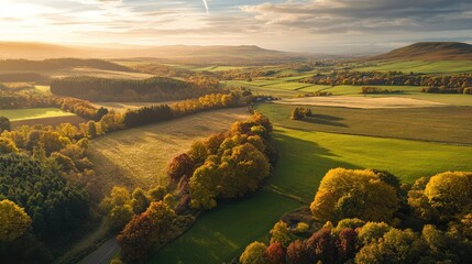 Aerial view of a stunning autumn landscape showcasing vibrant foliage and serene fields under a clear sky ideal for text overlay