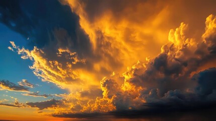 Obraz premium Stunning sunset clouds illuminating the sky with vibrant hues of orange and gold during a dramatic evening landscape display.