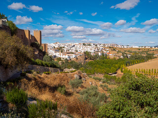 A scenic panorama from ancient city walls, across the countryside, surrounding Ronda in the Serranía de Ronda mountain range of Andalucia in southern Spain.