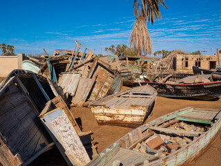 Derelict buildings and abandoned ruins of sailing boats at Khraibeh Beach, a coastal village on the Red Sea shoreline of Neom in Tabuk Province, Saudi Arabia.