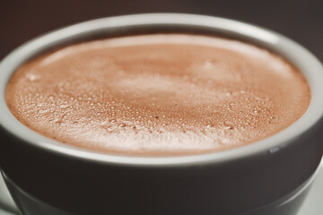 closeup of hot cocoa drink on walnut wood table