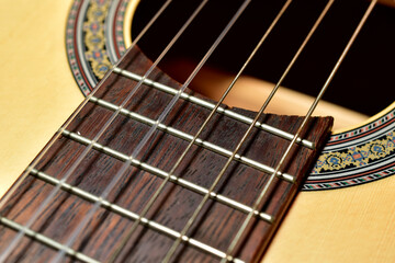 Obraz premium Acoustic guitar with sound hole. Close-up of strings.