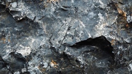 Close-up of a black and white stone texture with a rugged, dimensional mountain-like surface, creating a grunge background with space for design