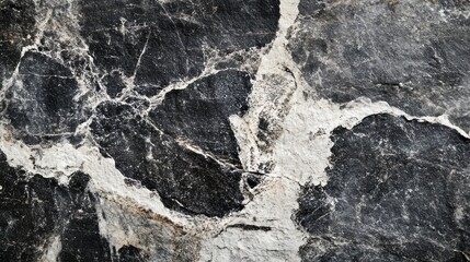 Fototapeta premium Grunge-inspired black and white stone texture, emphasizing natural mountain patterns and depth, perfect for design use